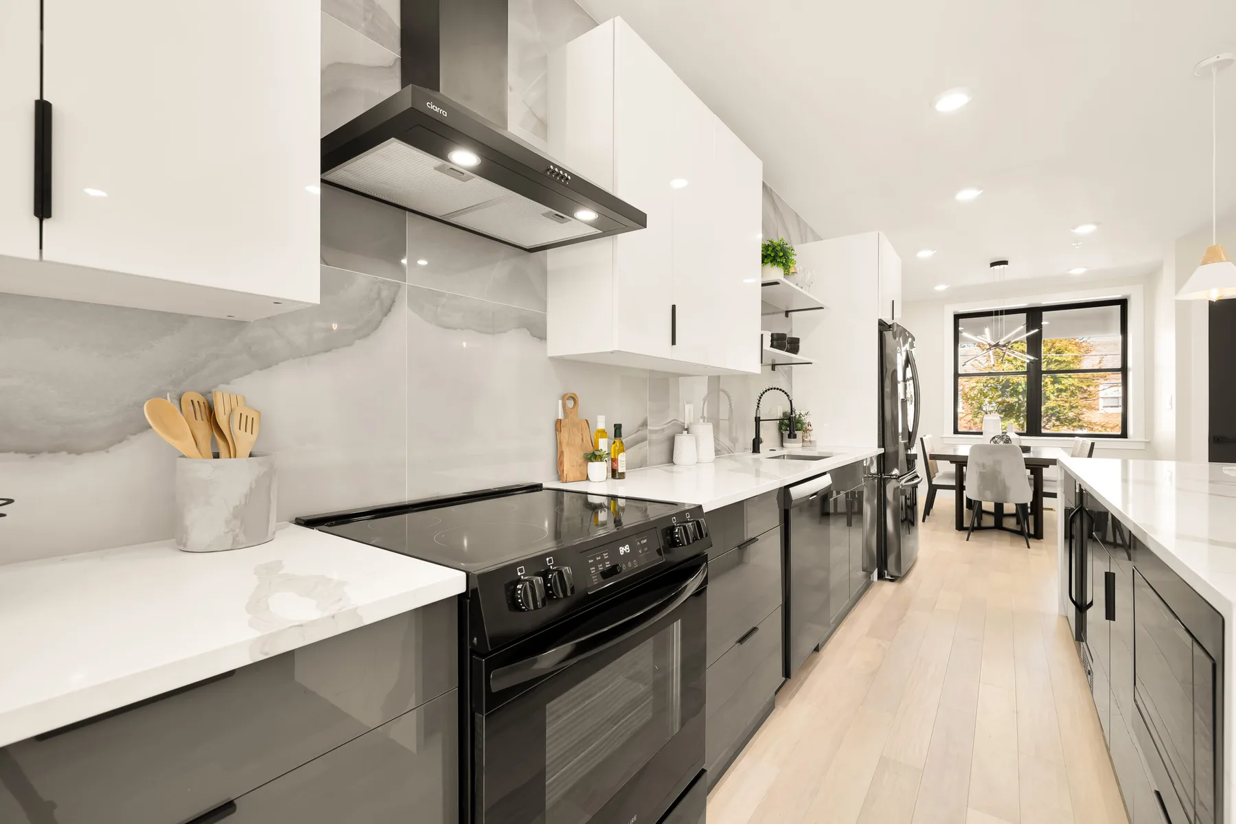A galley kitchen opening onto a light-filled living area