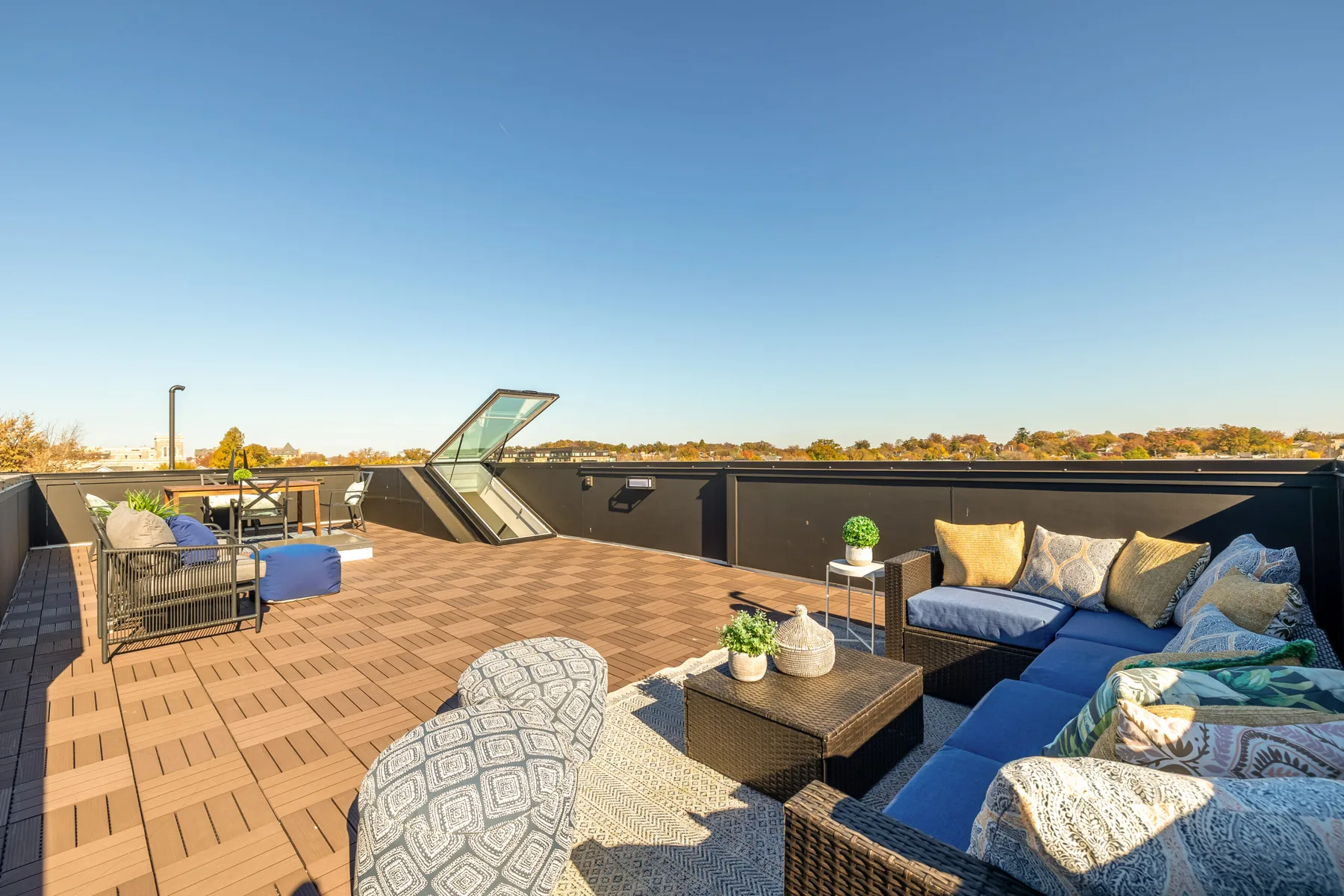 A rooftop terrace with seating and views over the neighborhood