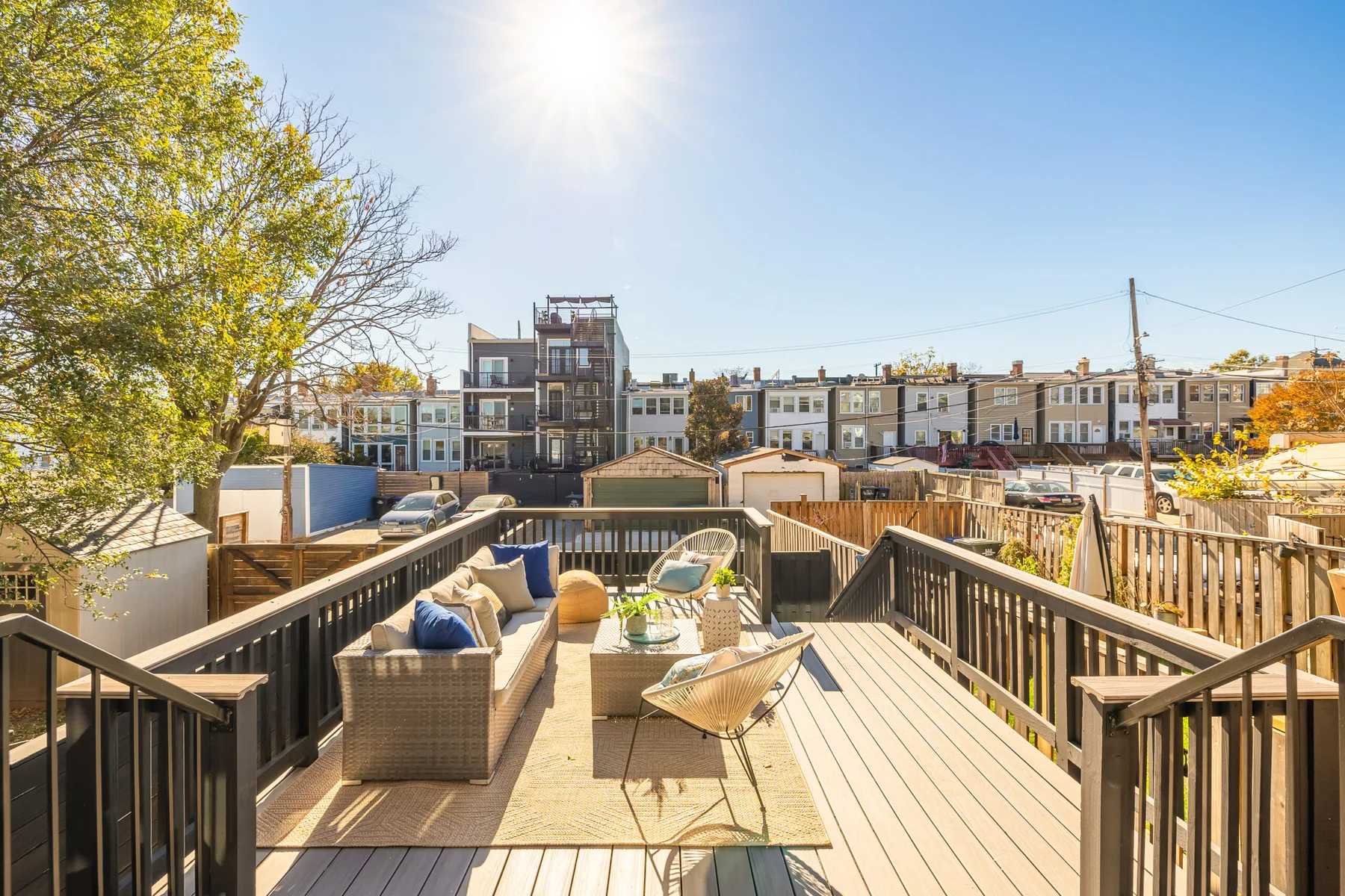 A rooftop space with seating and a pergola