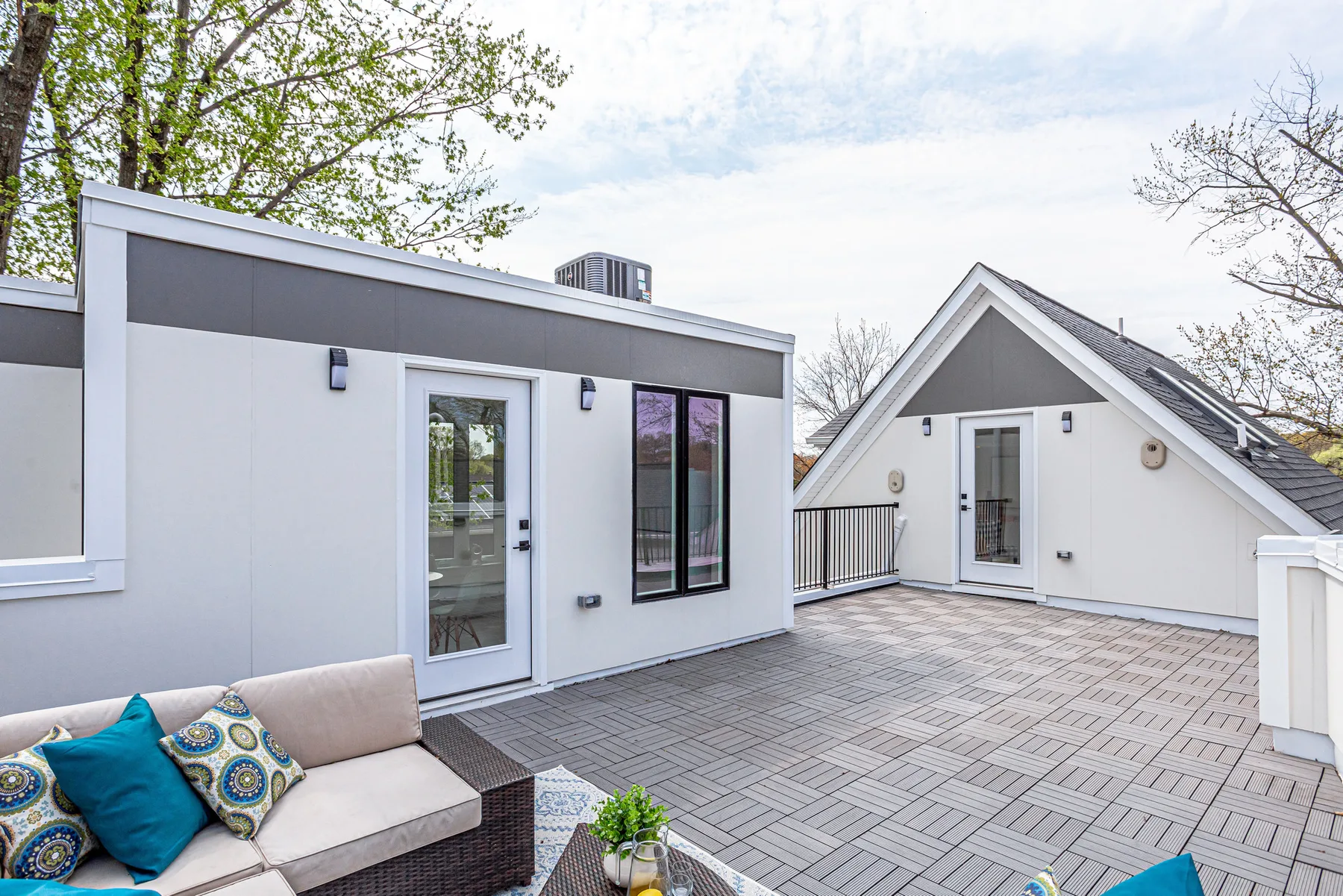 A finished rooftop deck adjoining a residential roof structure